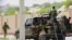 FILE - Somali soldiers are seen riding on a pick-up truck in Mogadishu, Somalia, April 27, 2022. 