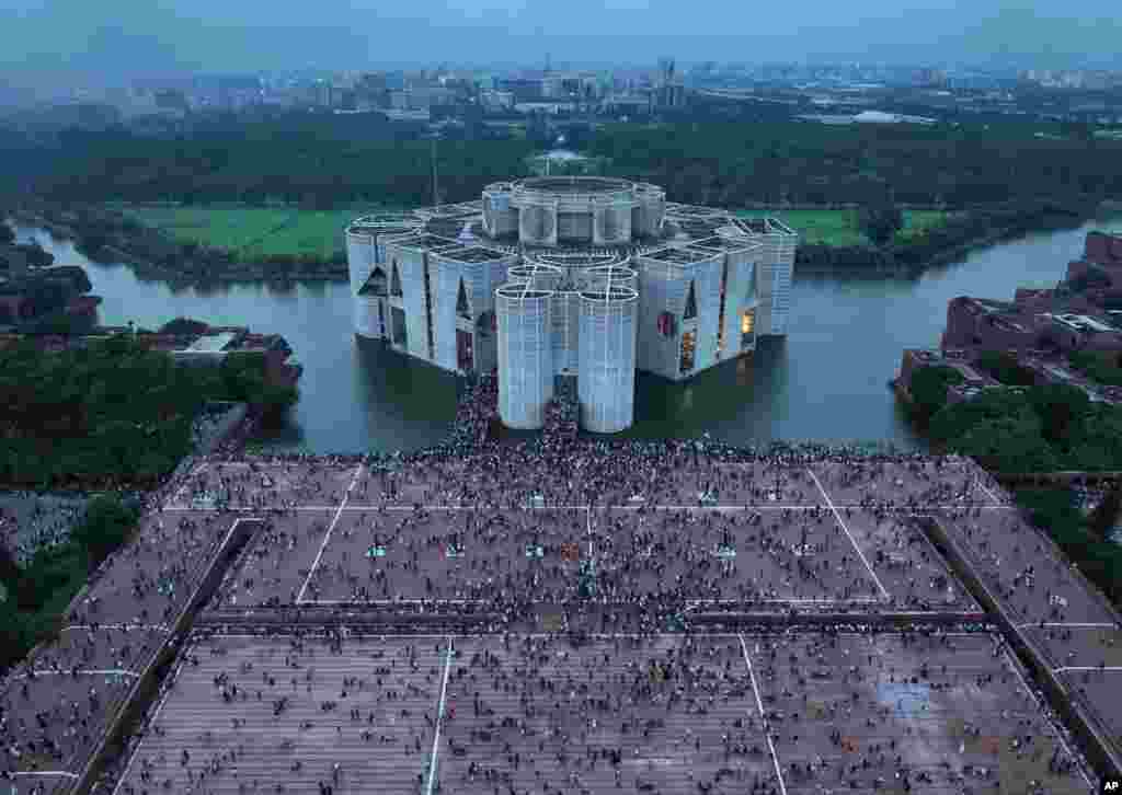 Protesters celebrate at the Parliament House premise after news of Prime Minister Sheikh Hasina's resignation, in Dhaka, Aug. 5, 2024.