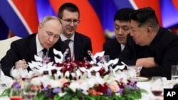 Russian President Vladimir Putin and North Korea's leader Kim Jong Un attend a State Reception after their talks in Pyongyang, North Korea, June 19, 2024. 