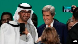 COP28 President Sultan Ahmed al-Jaber, the United Arab Emirates' special envoy for climate change, and John Kerry, U.S. special presidential envoy for climate, are pictured at the end of the COP28 U.N. Climate Summit, Dec. 13, 2023, in Dubai, UAE.