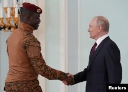 Russian President Vladimir Putin shakes hands with the leader of Burkina Faso junta Ibrahim Traore during a meeting following the Russia-Africa summit in Saint Petersburg, Russia, July 29, 2023. (Sputnik/Alexei Danichev/via REUTERS )