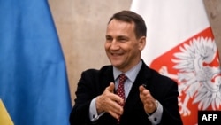 FILE - Polish Foreign Minister Radoslaw Sikorski speaks to reporters during his visit in Kyiv, Dec. 22, 2023.
