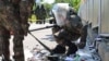 South Korean soldiers wearing protective gear check the trash from a balloon presumably sent by North Korea, in Incheon, South Korea, June 2, 2024. 