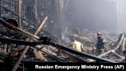 In this photo released by Russian Emergency Ministry Press Service on March 23, 2024, firefighters work in the burned concert hall after an attack on the building of the Crocus City Hall in Moscow, Russia. (Russian Emergency Ministry Press Service via AP)