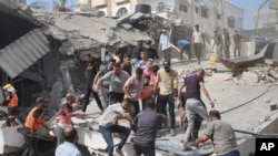 Palestinians look for survivors after the Israeli bombardment of the Gaza Strip in Deir Al-Balah, Oct. 22, 2023.