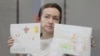 American-Russian journalist for Radio Free Europe/Radio Liberty (RFE/RL) Alsu Kurmasheva, holds drawings by her supporters as she attends a court hearing in Kazan, Russia, May 31, 2024. 