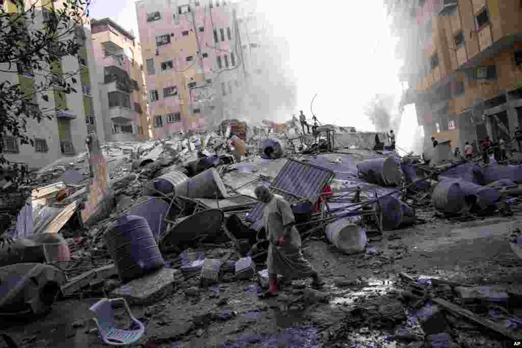 Palestinians inspect the rubble of a building after it was struck by an Israeli airstrike in Gaza City, Oct. 7, 2023.&nbsp;