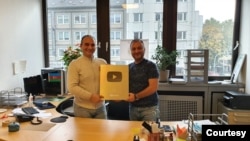 Aziz Orujov, left, and Anar Orujov, right, celebrate Kanal 13 reaching 1 million subscribers on YouTube in October, 2022. Aziz Orujov was arrested in late November on illegal construction charges that media advocates view as retaliatory. (Photo courtesy of Ulviyya Mammadova)