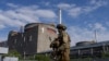 FILE - A Russian serviceman patrols the territory of the Zaporizhzhia Nuclear Power Station in Ukraine, May 1, 2022.
