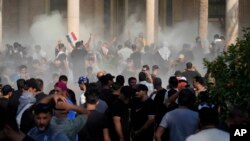 Iraqi security forces fire tear gas on the followers of Shiite cleric Muqtada al-Sadr inside the government Palace, Baghdad, Iraq, Aug. 29, 2022.