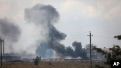 Smoke rises over the site of explosion at an ammunition storage of Russian army near the village of Mayskoye, Crimea, Aug. 16, 2022. On Aug. 19, 2022, another munitions fire led to the evacuation of two Russian villages near the Ukraine border.