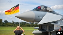 FILE - This Aug. 20, 2020, photo shows a man taking pictures of an Eurofighter jet of the German Air Force on the tarmac of the German Armed Forces airbase in Noervenich. Human rights lawyers filed an appeal to stop German exports of war weapons to Israel.