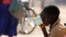 FILE - A child drinks water from a cup in drought-hit Masvingo, Zimbabwe.