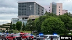Emergency personnel work at the scene of a shooting at the Natalie Medical Building in Tulsa, Okla., June 1, 2022. 