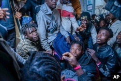 Migrants on the deck of the Rise Above rescue ship run by the German organization Mission Lifeline, in the Mediterranean Sea off the coasts of Sicily, southern Italy, Nov. 6, 2022.