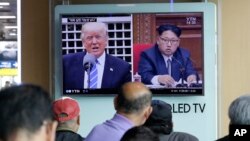 A TV screen shows images of U.S. President Donald Trump, left, and North Korean leader Kim Jong Un during a news program at the Seoul Railway Station in Seoul, South Korea.