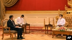 In this photo provided by the Military True News Information Team, Myanmar State Administration Council Chairman Senior General Min Aung Hlaing, talks with Cambodian Foreign Minister and ASEAN Special Envoy to Myanmar Prak Sokhonn during a meeting in Naypyitaw, March 21, 2022.