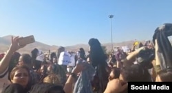 FILE - A screenshot of video circulating on social media purports to show women in Saghez, Iran, removing their headscarves in protest against the death of 22-year-old Mahsa Amini, who died after being detained by morality police enforcing strict hijab rules.
