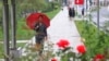 People walk after a rain in the Central District, Pyongyang, North Korea, on Sept. 14, 2022. 