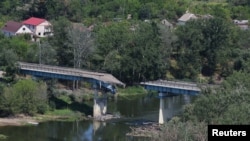 FILE - A view of the destroyed bridge linking Sievierodonetsk with Lysychansk, during the Ukraine-Russia conflict, as seen from Lysychansk, in the Luhansk region, Ukraine, July 4, 2022.