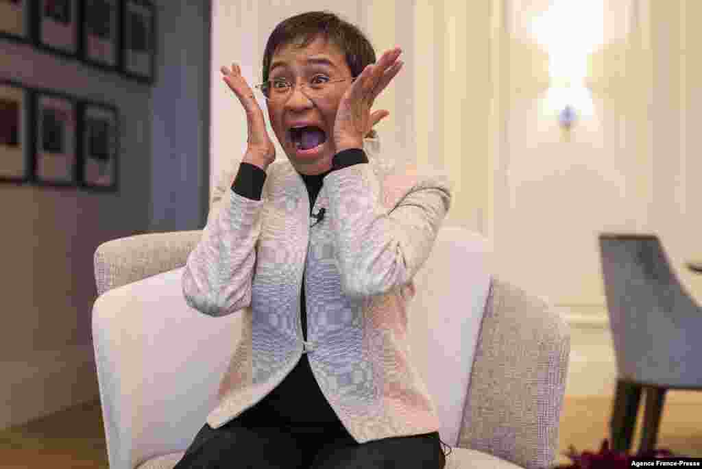 Nobel Peace Prize laureate Maria Ressa of the Philippines immitates the painting "Scream" by Norwegian painter Edvard Munch when asked about how she reacted to winning the award, in Oslo..