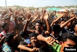 Hundreds of Rohingya refugees shout slogans as they protest against their repatriation at the Unchiprang camp in Teknaf, Bangladesh