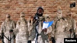 FILE - Boko Haram leader Abubakar Shekau speaks in front of guards at an unknown location in Nigeria in this still image taken from an undated video obtained Jan. 15, 2018. 