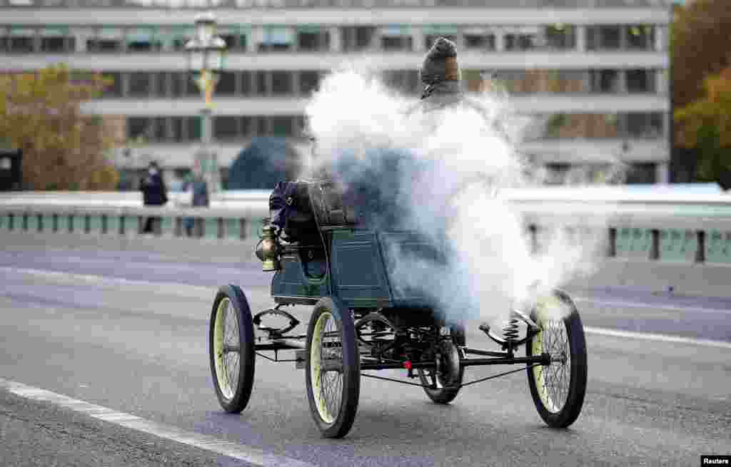 Participants in the "London to Brighton Veteran Car Run" cross Westminster Bridge in London, Nov. 7, 2021.
