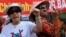 FILE - Bui Thi Minh Hang (R), 47, shouting anti-China slogans next to dissident lawyer Cu Huy Ha Vu's wife, Nguyen Thi Duong Ha (L), during an anti-China protest in downtown Hanoi.