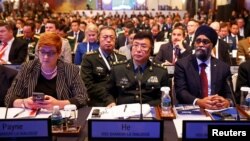 Australia's Defense Minister Marise Payne, from left, China's PLA Lieutenant-General He Lei and Canada's Defense Minister Harjit Sajjan listens to U.S. Secretary of Defense Jim Mattis' address at the Shangri-la Dialogue in Singapore, June 2, 2018.