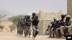 FILE- Nigerian special forces and Chadian troops participate with U.S. advisers in the Flintlock exercise in Mao, Chad, March 7, 2015. (AP Photo/Jerome Delay)