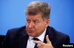 FILE - International Labor Organization Director-General Guy Ryder attends a news conference after a meeting at the Chancellery in Berlin, Oct. 1, 2019.