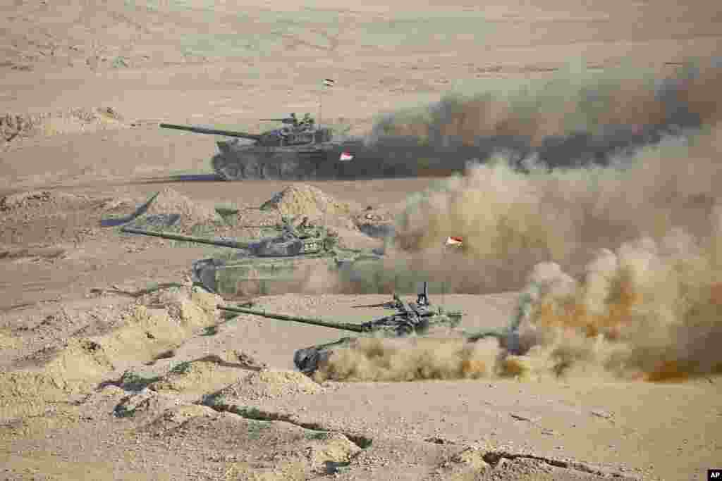 Tajikistan's tanks roll during a joint military drills by Russia and Uzbekistan at Harb-Maidon firing range about 20 kilometers (about 12 miles) north of the Tajik border with Afghanistan, in Tajikistan.