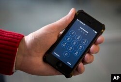 An iPhone is pictured in Washington, Feb. 17, 2016. Border agents have long had the right to search travelers' physical luggage without a warrant, and that interpretation has been expanded to include digital devices.