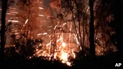This photo provided by Shane Turpin shows results of the eruption from Kilauea Volcano on Hawaii's Big Island, May 4, 2018. The eruption sent molten lava through forests and bubbling up from paved streets and forced the evacuation of about 1,700 people.