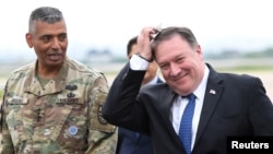 U.S. Secretary of State Mike Pompeo walks with U.S. General Vincent K. Brooks, commander of United States Forces Korea, upon his arrival at Osan Air Base in Pyeongtaek, South Korea, June 13, 2018.