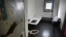 FILE - A Jan. 28, 2016, photo shows a solitary confinement cell known as "the bing," at New York's Rikers Island jail.