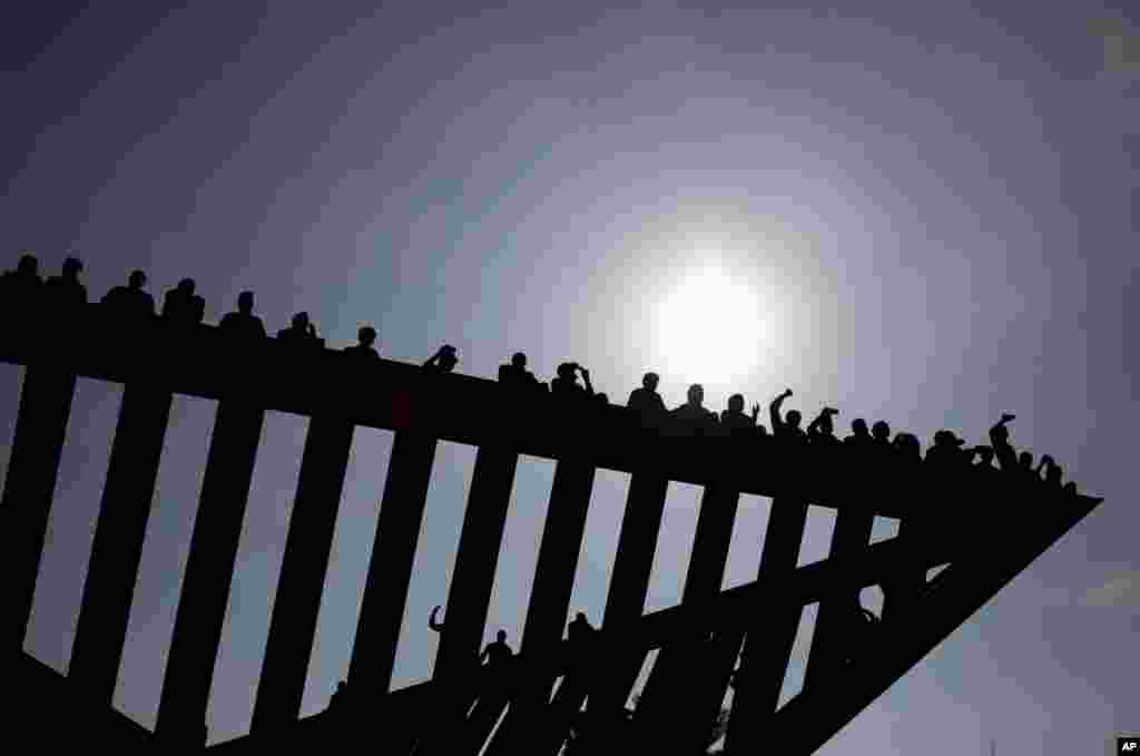 African migrants sit on top of a Holocaust memorial installation in Rabin's square, demanding work rights and better treatment from the Israeli government, in Tel Aviv, Israel, Jan. 5, 2014. 