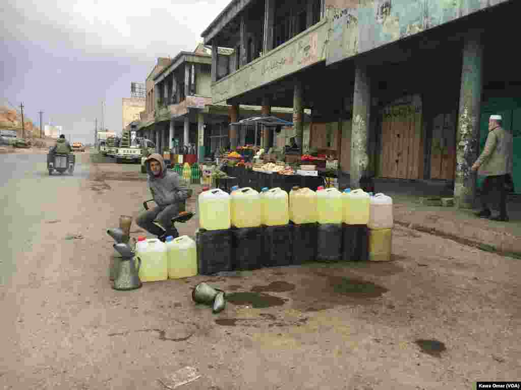 A young man sells gas on a public road, Jazair neighborhood, east of Mosul.