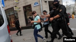 FILE - Law enforcement officers detain journalists in Minsk, Belarus, July 28, 2020. Many have been stripped of their accreditation Saturday.