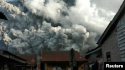 A volcanic ash cloud from Mount Sinabung hovers over Karo, North Sumatra, Indonesia June 9, 2019, in this still image taken from a from social media video. 