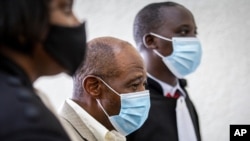 Paul Rusesabagina, center, who inspired the film 'Hotel Rwanda' for saving people from genocide, appears at the Kicukiro Primary Court in Kigali, Rwanda, on Sept. 14, 2020.