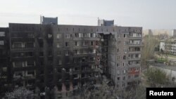 A view shows a residential building damaged during Ukraine-Russia conflict in the southern port city of Mariupol, Ukraine April 19, 2022. Picture taken with a drone. (REUTERS/Pavel Klimov)