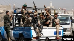 Houthi troops ride on the back of a police patrol truck after participating in a Houthi gathering in Sanaa, Yemen February 19, 2020. (REUTERS/Khaled Abdullah)