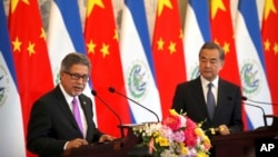 El Salvador's Foreign Minister Carlos Castaneda, left, speaks as China's Foreign Minister Wang Yi listens at a signing ceremony to mark the
establishment of diplomatic relations between El Salvador and China at the Diaoyutai State Guesthouse in Beijing, Aug. 21, 2018.