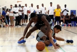The participants of the Jr. NBA World Championship battle for the ball during the a basketball tournament for the top 13- and 14-year-old boys and girls teams for the NBA and FIBA's global basketball development and community outreach program.