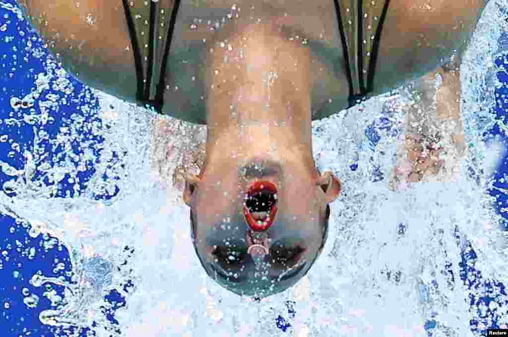 A member of the French duet performs during the women's duet free routine final of artistic swimming at the Tokyo Aquatics Center in Tokyo, Japan.
