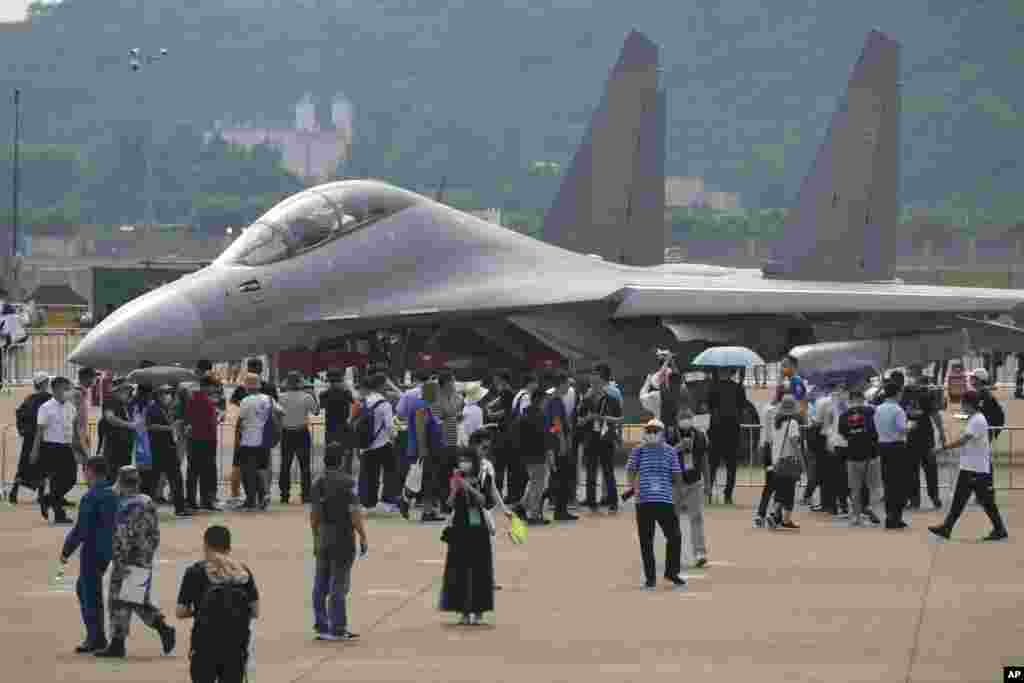 Visitors look at the Chinese military's J-16D electronic warfare airplane during the 13th China International Aviation and Aerospace Exhibition, also known as Airshow China 2021, in Zhuhai, Guangdong.