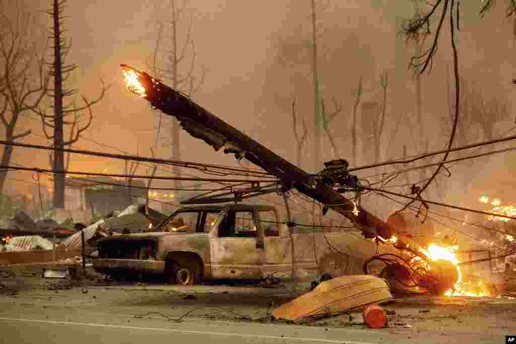 A utility pole burns as the Dixie Fire tears through the Greenville community of Plumas County, California, Aug. 4, 2021.