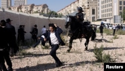 FILE - Ultra-Orthodox Jews protest against plans for conscription discussed by Israel's Supreme Court on June 2, 2024.